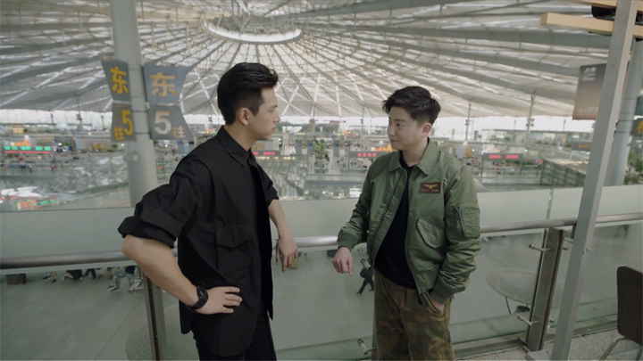 Han Shangyan and Buff at upper level of train station.