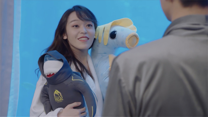 Zhou Shan in a robe with plushies.