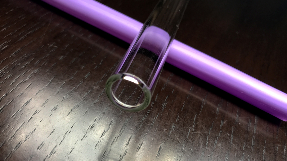 Wide glass straw end close up.